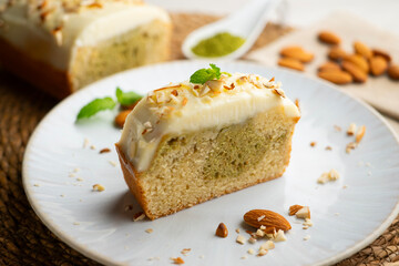 Slice of Japanese sponge cake with matcha green tea and a butter and cream cheese topping.
