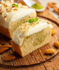 Slice of Japanese sponge cake with matcha green tea and a butter and cream cheese topping.