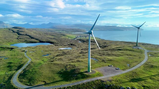 huge windmills green energy transition Faroe Islands, where rolling hills meet wind turbines against a backdrop of serene waters and dramatic skies. Nature thrives in perfect harmony.