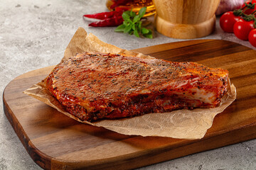 Raw marinated pork loin steak