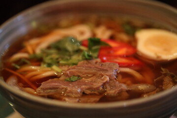 A warm bowl of meat and vegetable soup