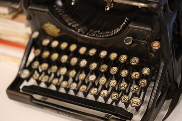 A classic vintage typewriter placed on a wooden table, ready for use