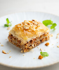 Baklava is a pastry made with a paste of crushed walnuts, spread on a filo pastry and covered in syrup or honey syrup.