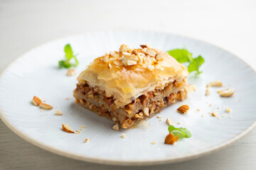 Baklava is a pastry made with a paste of crushed walnuts, spread on a filo pastry and covered in syrup or honey syrup.