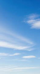 Fototapeta premium Bright blue sky with wispy clouds and clear atmosphere