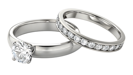 Close up of two wedding rings one with a large diamond and one with smaller diamonds set in the band