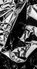 Closeup of crumpled aluminum foil with reflective texture and sharp edges