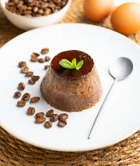 Homemade chocolate and coffee flan decorated with fresh mint. Traditional egg recipe.