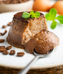 Homemade chocolate and coffee flan decorated with fresh mint. Traditional egg recipe.