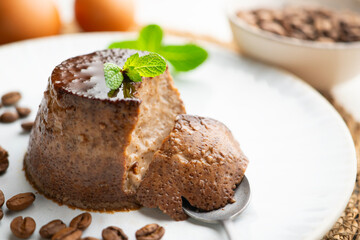 Homemade chocolate and coffee flan decorated with fresh mint. Traditional egg recipe.
