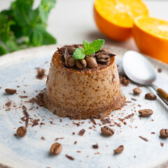Homemade chocolate and coffee flan decorated with fresh mint. Traditional egg recipe.