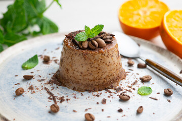 Homemade chocolate and coffee flan decorated with fresh mint. Traditional egg recipe.