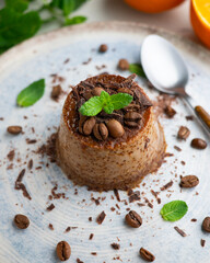 Homemade chocolate and coffee flan decorated with fresh mint. Traditional egg recipe.