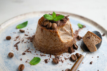 Homemade chocolate and coffee flan decorated with fresh mint. Traditional egg recipe.