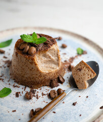 Homemade chocolate and coffee flan decorated with fresh mint. Traditional egg recipe.