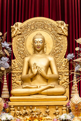 Fototapeta premium holy golden buddha sculpture in monastery interior