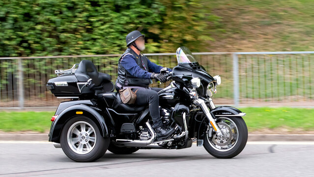 Milton Keynes,Bucks,UK - Aug 3rd 2025:  2016 black Harley davidson Tri Glide Ultra trike  motorcycle travelling on a British road