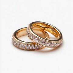 Two gold rings, set with numerous small diamonds, lie on a white background