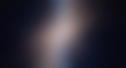 Obraz premium Dark and moody abstract background with a soft, blurred light source and fine-grain texture, perfect for sophisticated designs and professional presentations