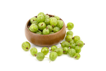 Fresh green gooseberries in a wooden bowl, surrounded by scattered berries, showcasing vibrant colors and natural textures, perfect for culinary or health-related concepts