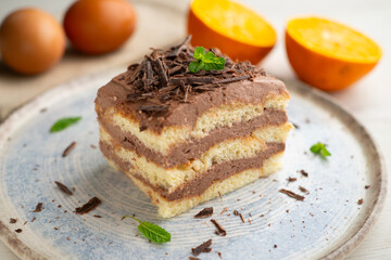 Tiramisu cake with chocolate and coffee cream. A traditional recipe made with sponge cake.