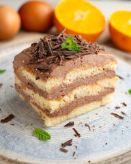 Tiramisu cake with chocolate and coffee cream. A traditional recipe made with sponge cake.