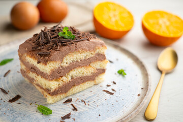 Tiramisu cake with chocolate and coffee cream. A traditional recipe made with sponge cake.