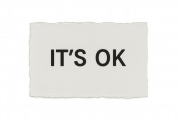 White paper ripped, revealing handwritten black text it's ok - minimalist design communicating emotional support and healing message