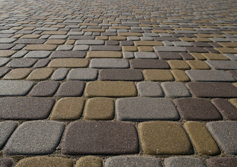 Modern tricolor paving stones glistening in the sunlight, close-up. Background