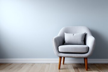 A light gray armchair sits gracefully against a pale blue wall, highlighting the simple elegance of modern interior design.