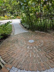 Circular brick paving in a tropical garden