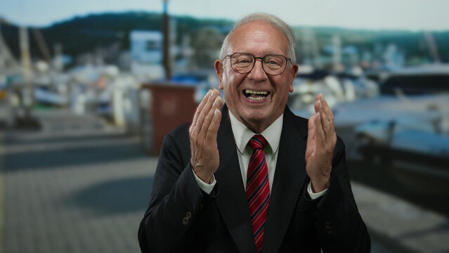 Senior man in suit smiling by seaside promenade, showcasing happiness and success in an outdoor business setting. - Powered by Adobe