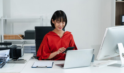 Businesswomen working with tablet and using a calculator to calculate the tax of static in office. Finance accounting concept.