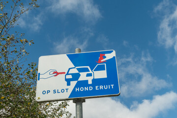 Road sign showing locking car and taking dog out in dutch language