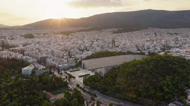 Panathenaic Stadium near the National Garden, the Zappeion Exhibition Hall, and the residential area of Pangrati at sunrise, Athens, Drone shot, Establishing