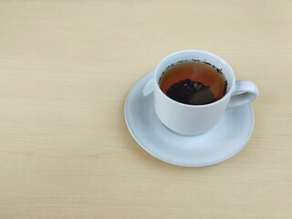 A cup of hot tea on wooden table background, Copy space 