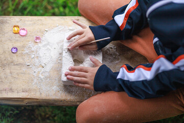 Child Excavating Gemstones Block Outdoors