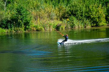 Water sports enthusiasts on a small river on a sunny day.