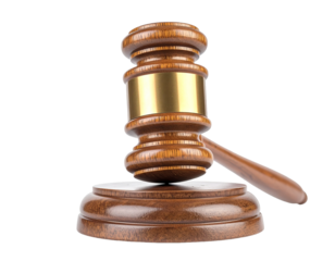 Judge's gavel with gold band on a wooden sound block with white background.