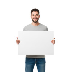 Young caucasian man, short dark curly hair, beard, grey t-shirt, blue jeans, cheerful smile. Holding blank white sign in transparent studio background with copy space. Concept for commercial
