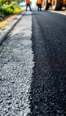 Fototapeta premium Road under construction with fresh asphalt and gravel