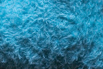 Soft synthetic light blue curly wool as background or wallpaper with fleecy texture and fluffy surface