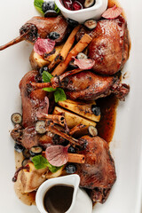 Gourmet duck legs with cinnamon, berries, and sauce