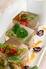 Gourmet aspic cubes with herbs and chili