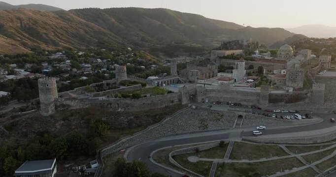 Aerial view of Rabati Castle, with its stone walls and towers, surrounded by a town nestled against green hills, Akhaltsikhe, Samtskhe-Javakheti, Georgia.