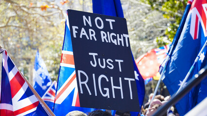 Obraz premium Protesters hold signs and flags during a demonstration Anti-immigration protest sign.Sydney Anti-immigration protest