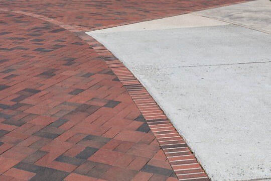Intersection of brick paths with concrete pads, sweeping curve creative copy space, horizontal aspect