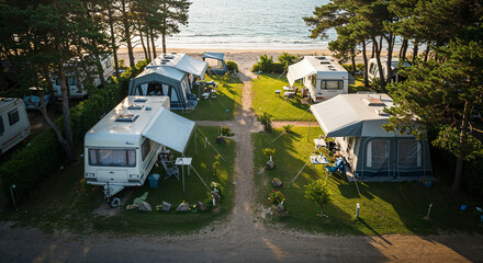 Close-up of caravans at a seaside camping site with greenery.
