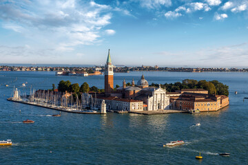 Panorama of the Venetian lagoon, view of the waterfront of St. Mark Square, San Giorgio Maggiore and boats floating on the bay.