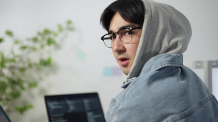 Cybersecurity professional working in a server room. - Powered by Adobe